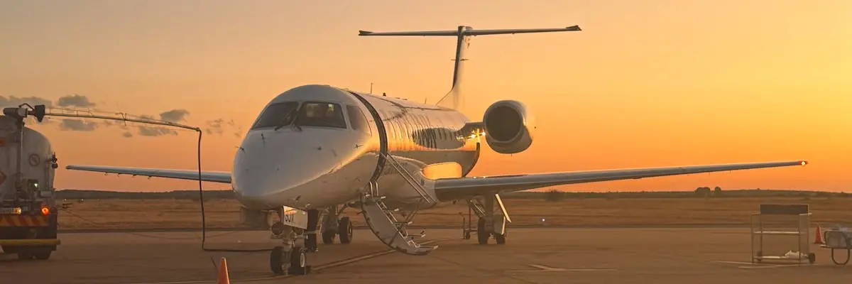 Private jet with ground support on the airport ramp